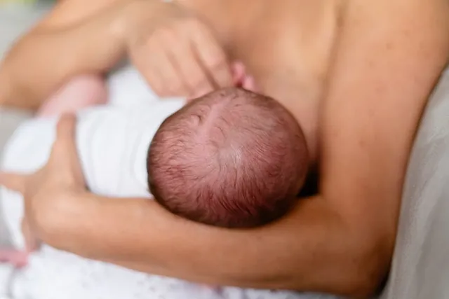 A mother breastfeeding her newborn